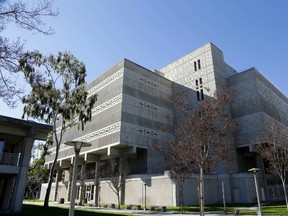 The exterior of Central Men's Jail in Santa Ana, Calif., is seen Monday, Jan. 25, 2016. Three inmates, including a man suspected of a killing, cut through metal, crawled through plumbing tunnels, climbed a roof and rappelled down four stories to freedom using ropes made from bedsheets. The three inmates very likely had help from the inside to pull off their daring plan, but they also have the complacency of jail staff to thank, experts in jail and prison security said Monday.  (AP Photo/Nick Ut)