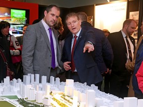 Senators defenceman Chris Phillips (left) and team president Cyril Leeder talk about the scaled model of the Illumination LeBreton redevelopment on Jan. 27 at the Canadian War Museum. (Jean Levac, Postmedia Network)