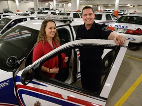 Sgt. Darren Couling gives Fanshawe student Jessica Proctor, 19, 
a tour Wednesday of London police headquarters. (MORRIS LAMONT, The London Free Press)
