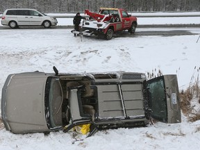 A SUV rolled over on it's side on Innes Road in Ottawa Thursday Jan 28, 2016. A man was sent to hospital after being removed from the SUV. Tony Caldwell/Postmedia Network
