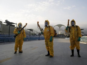 Municipal workers wait before spraying insecticide at Sambodrome in an effort to battle a mosquito-borne virus spreading rapidly across South America in Rio de Janeiro, Brazil, on Tuesday, Jan. 26, 2016. (Pilar Olivares/Reuters)