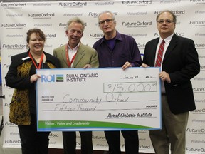 Kelly Gilson and Randy Peltz (left), co-chairs of Community Oxford, accept a cheque for $15,000 from the Rural Ontario Institute's Sam Coghlan (second from right) and Dean Anderson (right) at the Future Oxford Expo on Jan. 28, 2016. (MEGAN STACEY, Sentinel-Review)