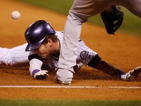 Colorado Rockies left fielder Corey Dickerson slides safely into third base against the Los Angeles Dodgers at Coors Field. (Chris Humphreys/USA TODAY Sports)