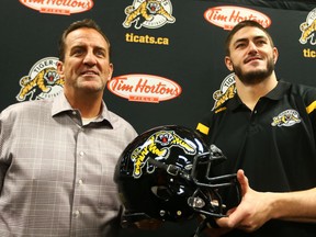 Hamilton Tiger-Cats head Coach and GM Kent Austin (left) introduces John Chick at a press conference in Hamilton Thursday January 28, 2016. (Dave Abel/Toronto Sun/Postmedia Network)