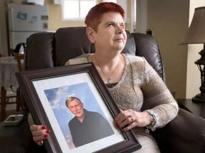 Sharlene Pietersma holds a photo of her husband Danny who was killed in a home invasion. (WAYNE CUDDINGTON / OTTAWA CITIZEN)