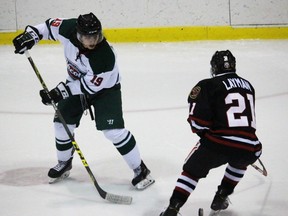 Brody Smith of the St. Marys Lincolns slips the puck through Sarnia Legionnaires forward Brandon Layman during the Greater Ontario Junior Hockey League game at Sarnia Arena on Thursday, Jan. 28, 2016 in Sarnia, Ont. The Legionnaires collected a 6-3 victory. (Terry Bridge, The Observer)