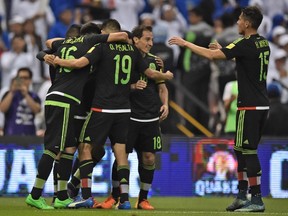 Mexico players celebrate a goal against El Salvador in World Cup qualifying. (AFP)
