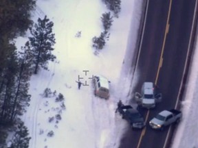 This photo taken from an FBI video shows Robert "LaVoy" Finicum before he was fatally shot by police Tuesday, Jan. 26, 2016 near Burns, Ore.  A video released Thursday, Jan. 28, 2016 by the FBI of the shooting death of a spokesman for the armed occupiers of a wildlife refuge shows the man reaching into his jacket before he fell into the snow. The FBI said the man had a gun in his pocket. (FBI via AP)