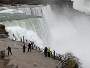 In this April 11, 2012 file photo, tourists visit the American Falls in Niagara Falls, N.Y. New York officials are considering temporarily turning Niagara Falls into a trickle. (AP Photo/David Duprey, File)