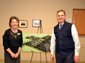 Real estate agent Michelle Chessell (left) and developer Michael Van Pelt pose with a concept site design sketch for the proposed Upper Thames Village at an information meeting in the Mitchell Golf and Country Club Jan. 27. GALEN SIMMONS/MITCHELL ADVOCATE