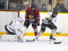 Mitchell Hawks' Jake Finlayson (26) and Chace Duckworth look to score against the WIngham Ironmen during regular season action from earlier this season. ANDY BADER/MITCHELL ADVOCATE FILE PHOTO