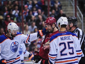 Edmonton Oilers left winger Luke Gazdic and defenceman Darnell Nurse shove Arizona Coyotes left winger John Scott after a whistle in the second period at Gila River Arena in Glendale on Nov, 12, 2015. (Matt Kartozian/USA TODAY Sports)