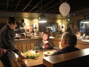 Attendees were being served complimentary drinks and appetizers at the night of the opening of a new restaurant in Drayton Valley.