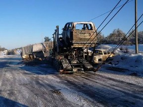 Wreckage is removed from the scene of a multi-vehicle collision on Highway 69 about 60 kilometres north of Parry Sound, Ont., on Friday, Jan. 29, 2016. (THE CANADIAN PRESS/HO/Ontario Provincial Police)
