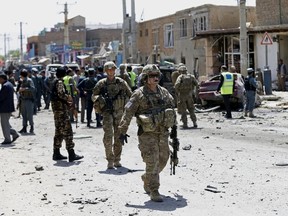 Mohammad Ismail/Reuters
U.S. soldiers arrive at the site of an attack in Kabul, Afghanistan, in May. A car bomb rammed a convoy of foreign troops near the main airport in Afghanistan's capital.