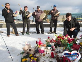 Prime Minister Justin Trudeau pauses for a moment as he lays a wreath outside the La Loche Community school in La Loche, Sask., Friday, Jan. 29, 2016. A 17-year-old boy allegedly shot two people at the school last Friday after shooting two brothers to death earlier at a home nearby. THE CANADIAN PRESS/Jonathan Hayward