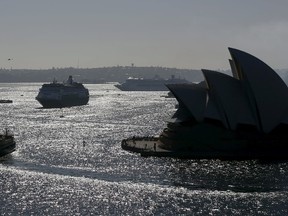 The Manly-bound ferry Collaroy (foreground) picks its way between cruise ships Pacific Jewel, centre, and Pacific Aria during a naming ceremony for the new P&O cruise ships on Sydney harbour, November 25, 2015. (REUTERS/Jason Reed)