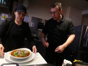 Edgardo Torres and his wife Minerva Carmona make some Pozole at their High Park restaurant, Aztec Mines. On Thursday, a patron threatened them like he was going to pull a gun from his pocket after dining at their restaurant. He was promptly kicked out. (Jack Boland/Toronto Sun/Postmedia Network)