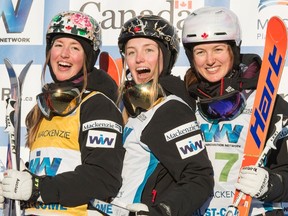 Moguls winner Justine Dufour-Lapointe is flanked on the podium by her sisters, second place Chloe, left, and third place Maxime, right, at the FIS Freestyle Ski World Cup Saturday, January 23, 2016 in Val St-Come, Que. (THE CANADIAN PRESS/Paul Chiasson)