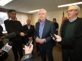 Justice Minister Gord Mackintosh put on a brave face in front of a few dozen staff and supporters jammed into his small constituency office on north Main Street Friday afternoon.