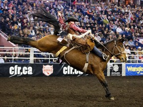 Cody DeMoss (Watervalley, AB) takes part in the Saddle Bronc Riding event during the final day of the Canadian Finals Rodeo at Rexall Place, in Edmonton, Alta. on Sunday Nov. 15, 2015.