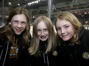 Greater Kingston Jr. Frontenacs minor peewee players, from left, Grayson Ebrahim, Jake McLellan and Lane Morency grew their hair for cancer fundraising and shaved it all off at the Kingston Frontenacs game at the Rogers K-Rock Centre on Friday. (Ian MacAlpine/The Whig-Standard)