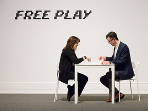 Museum London curator of art Cassandra Getty and marketing co-ordinator Matt Thomas play an installation by Yoko Ono, titled Play It By Trust, in the Free Play exhibition at Museum London. (CRAIG GLOVER, The London Free Press)