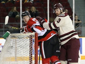 Peterborough Petes’ Brandon Prophet shoves Connor Warnholtz of the Ottawa 67’s into the net during Ontario Hockey League action on Jan. 29. (Jana Chytilova/postmedia network)