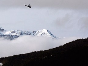 A Search and Rescue helicopter heads toward the area where a large avalanche struck near Revelstoke, B.C., in this Sunday, March 14, 2010 file photo. Five snowmobilers have died in a "very large'' avalanche near the interior community of McBride, B.C., prompting a rescue and recovery operation. (THE CANADIAN PRESS/Jeff McIntosh)