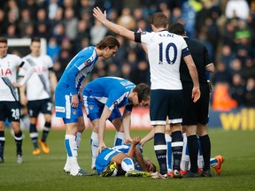 Colchester United's Alex Wynter lies on the ground injured after knocking heads with teammate Tom Eastman during FA Cup Fourth Round action  in Colchester, England, on Saturday, Jan. 30, 2016. (Paul Childs/Action Images via Reuters)