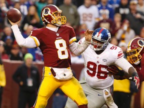 Redskins QB Kirk Cousins (8) throws the ball as Giants defensive tackle Jay Bromley (96) chases during fourth quarter NFL action at FedEx Field in Landover, Md., on Nov. 29, 2015. (Geoff Burke/USA TODAY Sports)