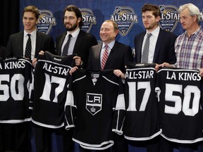 NHL commissioner Gary Bettman, centre, is joined by members of the Los Angeles Kings Saturday, Jan. 30, 2016, in Nashville, Tenn., after it was announced that the 2017 NHL hockey All-Star game will be held in Los Angeles. From left are Luc Robitaille, president of business operations, defenceman Drew Doughty, Bettman, goalie Jonathan Quick, and head coach Darryl Sutter. (AP Photo/Mark Humphrey)