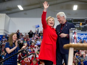 Democratic presidential candidate Hillary Clinton, accompanied by former President Bill Clinton, right, and their daughter Chelsea Clinton, left, arrives to speak at a rally at Washington High School in Cedar Rapids, Iowa, Saturday, Jan. 30, 2016. (AP Photo/Andrew Harnik)