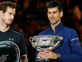 Serbia's Novak Djokovic (R) stands with the men's singles trophy beside Britain's Andy Murray after winning their final match at the Australian Open tennis tournament at Melbourne Park, Australia, January 31, 2016. REUTERS/Tyrone Siu