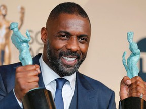Idris Elba holds the awards for Outstanding Performance by a Male Actor in a Supporting Role for his role in "Beasts of No Nation" and for Outstanding Performance by a Male Actor in a Television Movie or Miniseries for his role in "Luther" as he poses backstage at the 22nd Screen Actors Guild Awards in Los Angeles, California January 30, 2016. REUTERS/Mike Blake
