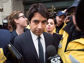 Jian Ghomeshi is escorted by police out of court past members of the media in Toronto on November 26, 2014. He was a broadcasting star with a wide and loyal following before he became engulfed in a scandal that sparked a nationwide conversation on sexual assault and the issues with reporting it. Now, more than a year since the allegations against Jian Ghomeshi sent shock waves across the country, his highly anticipated trial is set to begin in Toronto on Monday. THE CANADIAN PRESS/Darren Calabrese