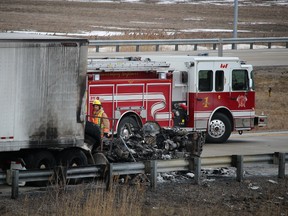 Fire and police officials on the scene of a fatal transport fire on westbound Highway 402, south of Sarnia, on Jan. 31, 2016. (BARBARA SIMPSON, Sarnia Observer)