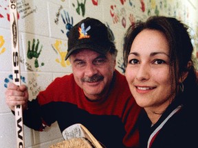 Don Marks (left) joined Diane Roussin to sell autographed hockey sticks to raise money for teenage mothers, one of many community efforts he made. (Archives)