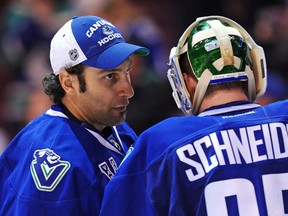 Roberto Luongo #1 of the Vancouver Canucks congratulates his teammate Cory Schneider #35 after defeating the Calgary Flames during an NHL game at Rogers Arena on April 6, 2013 in Vancouver, British Columbia, Canada. The Vancouver Canucks won 5-2.   Derek Leung/Getty Images/AFP