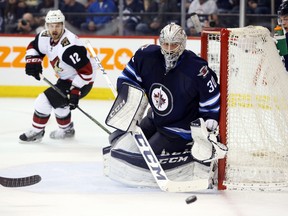 Winnipeg Jets goalie Connor Hellebuyck (30) watches a stray puck during the third period against the Arizona Coyotes at MTS Centre. Hellebuyck is evidence Kevin Cheveldayoff is enjoying his greatest successes at the draft table. (Bruce Fedyck-USA TODAY Sports)