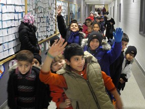Government-assisted Syrian refugee children leave to go back to the Cross Cultural Learner Centre after a day at a special welcome centre for them at White Oaks public school in London. The Thames Valley District school board welcome centre assesses families? literacy and numeracy levels and introduces them to school life in Canada. (KATE DUBINSKI, The London Free Press)