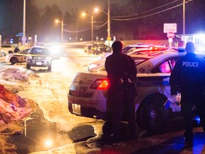 A man is detained by police after a fatal shooting in Nepean on Sunday night. James Park/Postmedia Network