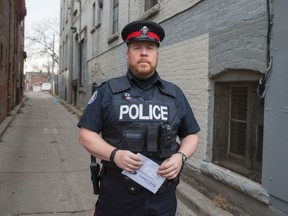 Const. Craig Brister, stands in an alley where a woman was sexually assaulted on Saturday night. (ERNEST DOROSZUK, Toronto Sun)