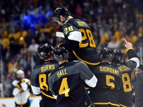 Pacific Division forward John Scott (28) of the Montreal Canadiens is picked up by his teammates after beating the Atlantic Division during the championship game of the 2016 NHL All Star Game at Bridgestone Arena. Christopher Hanewinckel-USA TODAY Sports