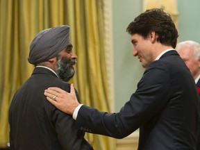 Newly sworn in Minister of National Defence Harjit Singh Sajjan is congratulated by Prime Minister Justin Trudeau during a ceremony at Rideau Hall, in Ottawa, on Wednesday, Nov. 4, 2015.