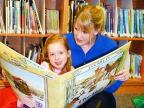 Meghan Wolfe took advantage of Upper Thames Elementary School's Family Literacy evening last Wednesday, Jan. 27 to read a big book entitled “The Hat” to her daughter Brynn in the school's library.  GALEN SIMMONS/MITCHELL ADVOCATE