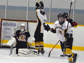 Carter Schoonderwoerd (right) and Reid Ramseyer of the Mitchell Bantams react to Calvin McCorkindale’s second goal of the game on the power play during second period action of their OMHA ‘CC’ playoff series with visiting Hanover last Friday, Jan. 29. Mitchell squared their six-point series with a 5-0 win, then took control with a 7-3 road win Sunday. ANDY BADER/MITCHELL ADVOCATE