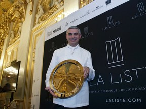 French Swiss Chef Benoit Violier of the restaurant Hotel de Ville in Crissier, Switzerland, poses with his trophy for the best restaurant of the World during the award ceremony of "La Liste" (The List) at the French Foreign Ministery in Paris, Thursday, Dec. 17, 2015.  Unveiled