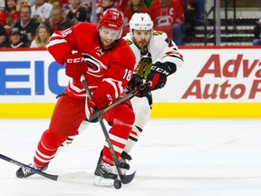 Carolina Hurricanes forward Jay McClement tries to get past Chicago Blackhawks defenceman Brent Seabrook during an NHL game in Raleigh, N.C. (James Guillory/USA TODAY Sports)
