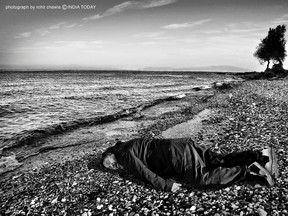 This Jan. 25, 2016, image provided by the India Today news magazine shows Chinese artist and activist Ai Weiwei posing as he lies face down on the beach on the Greek island of Lesbos. Chinese artist Ai Weiwei has recreated the famous image of a 3-year-old Syrian child who drowned in Turkey last year by staging a photo of himself lying face down on a beach in Greece. The photograph last year of the child lying on a Turkish beach triggered international outrage as people saw the helpless toddler as the devastating human face of the refugee crisis in Europe. (Rohit Chawla/India Today via AP)